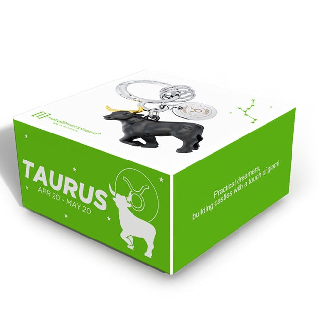 Metalmorphose.lt metalinis raktų pakabukas JAUTIS. Juodas Jaučio siluetas su auksiniais ragais, žemės ženklo 3D miniatiūra, premium cinko lydinys, nerūdijančio plieno žiedas. Pakabukas iš ZODIAKŲ PASAULIS kolekcijos.