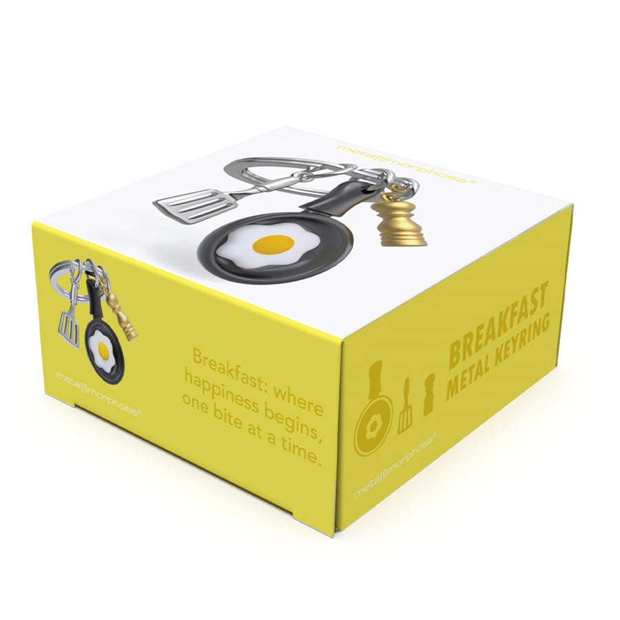 Metalinis raktų pakabukas „Pusryčių Magija“ su keptuvės ir kiaušinio 3D dizainu iš Metalmorphose SKONIŲ PASAULIS kolekcijos.
