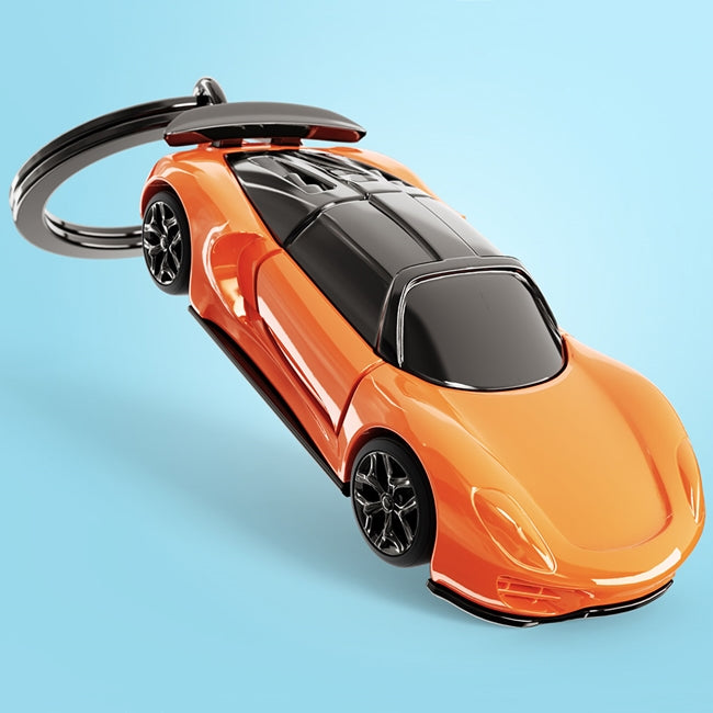 Metalmorphose.lt metalinis raktų pakabukas RYŠKUSIS SUPERAUTOMOBILIS. Ryškiai oranžinis superautomobilis su juodu stogu, tamsintais langais ir besisukančiais ratais. TRANSPORTO PASAULIS kolekcija.