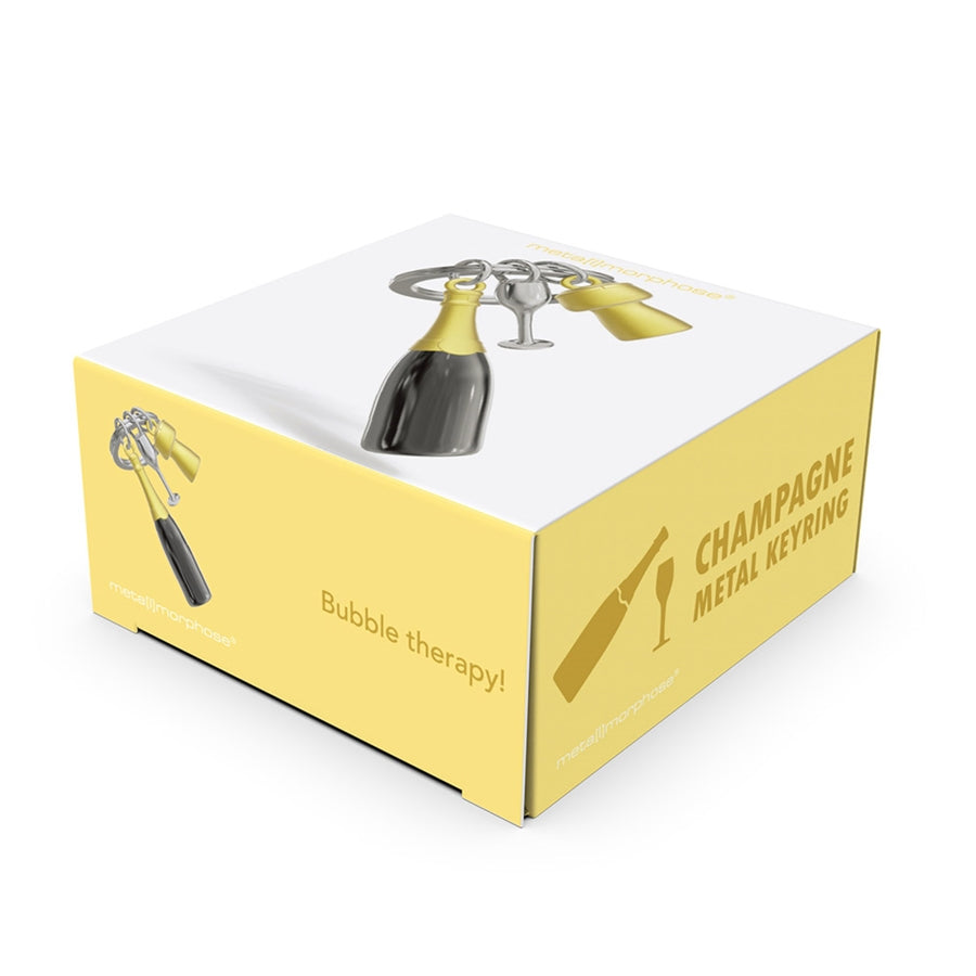 Metalinis raktų pakabukas „Šampano Akimirka“ – šampano butelio, su kamšteliu ir taurės 3D miniatiūra iš Metalmorphose „Skonių Pasaulis“ kolekcijos.